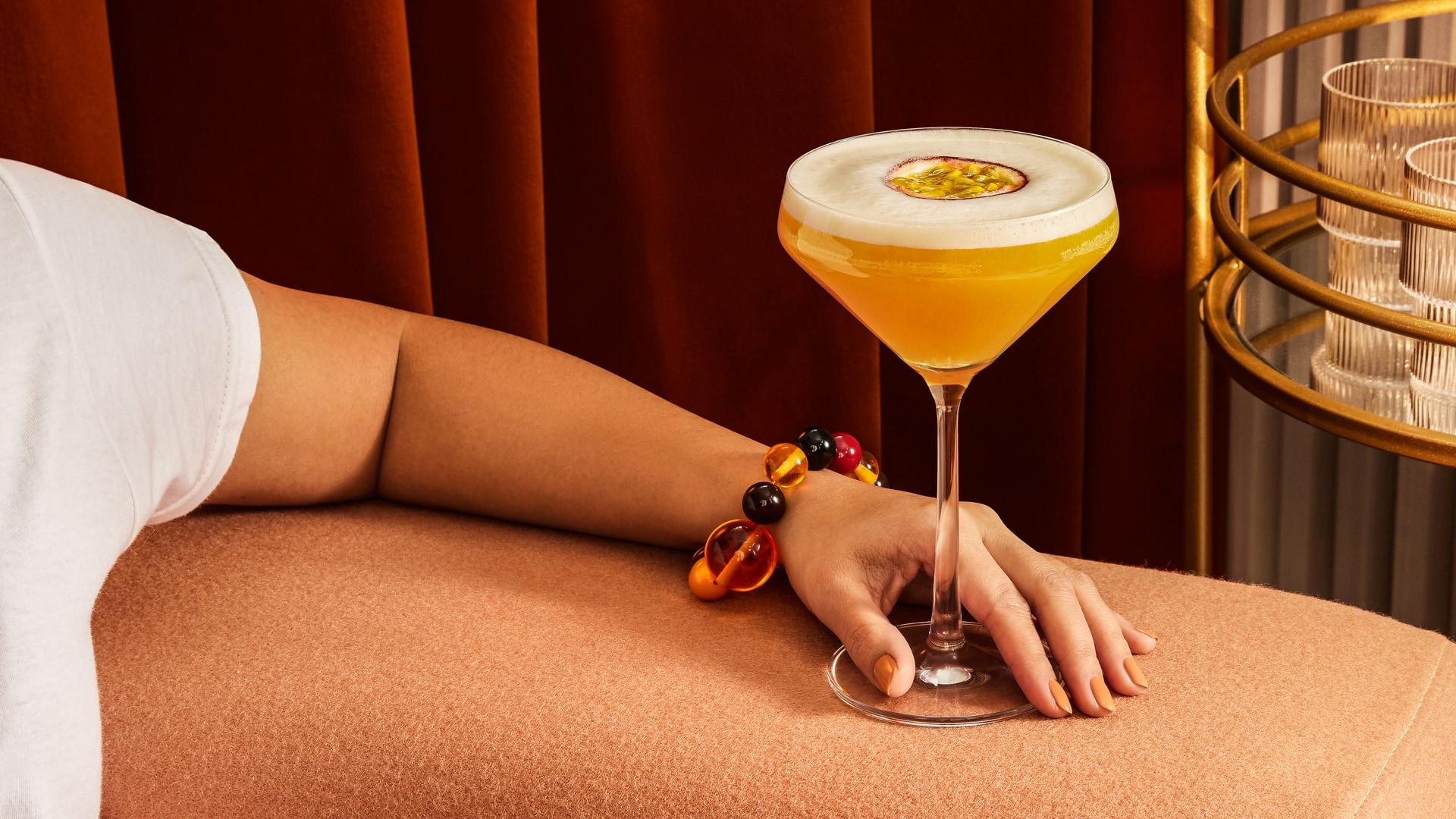 Passionfruit Martini cocktail on couch