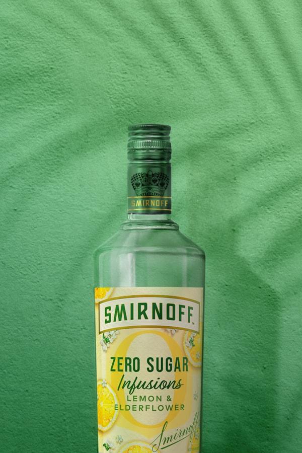 Smirnoff Zero Sugar Infusions Lemon & Elderflower on green tropical background