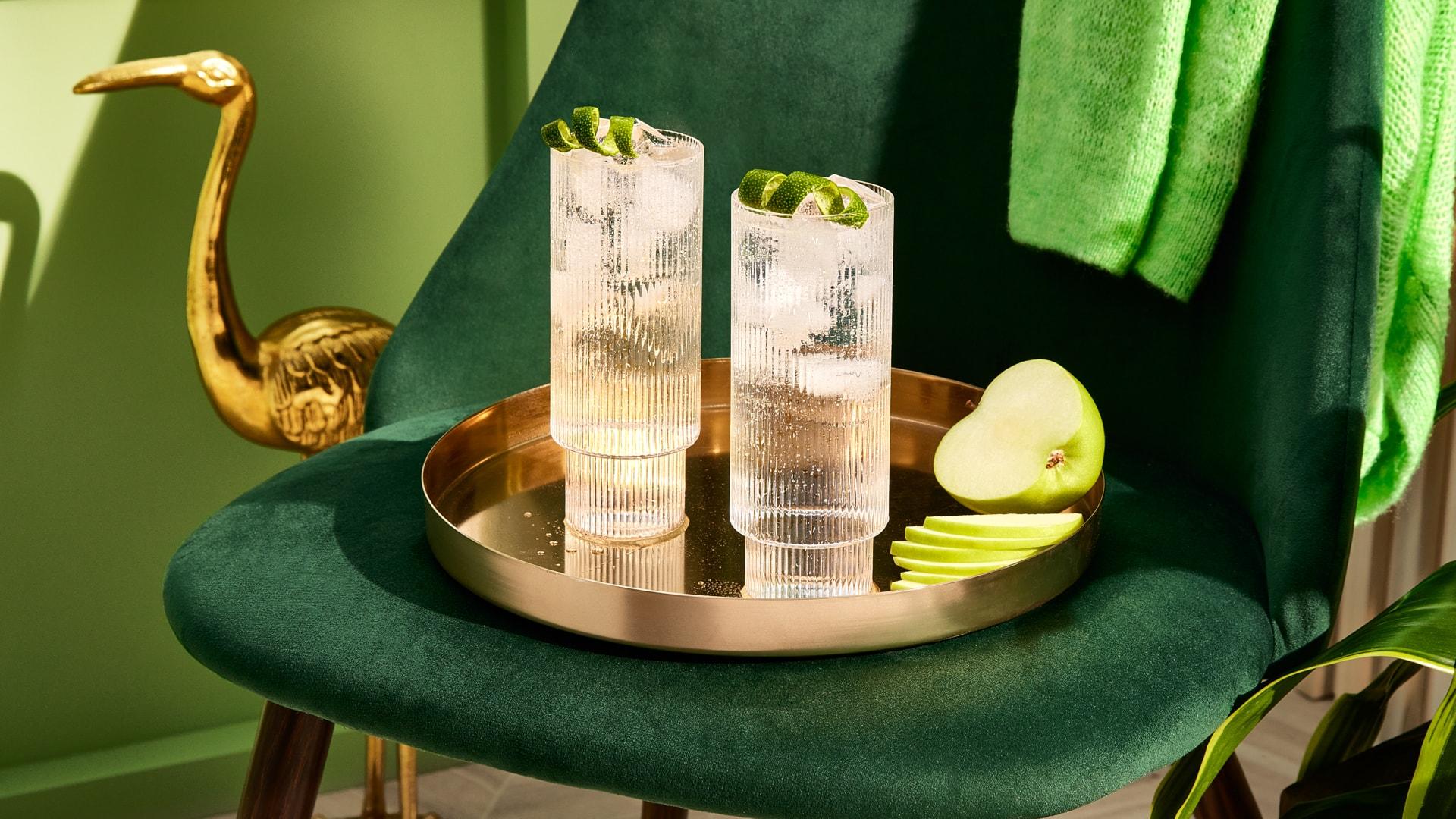 Two Smirnoff Green Apple Splash cocktails on a gold tray