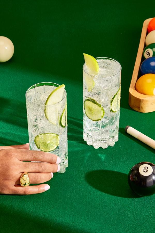 Two Smirnoff Green Apple Soda cocktails on a pool table