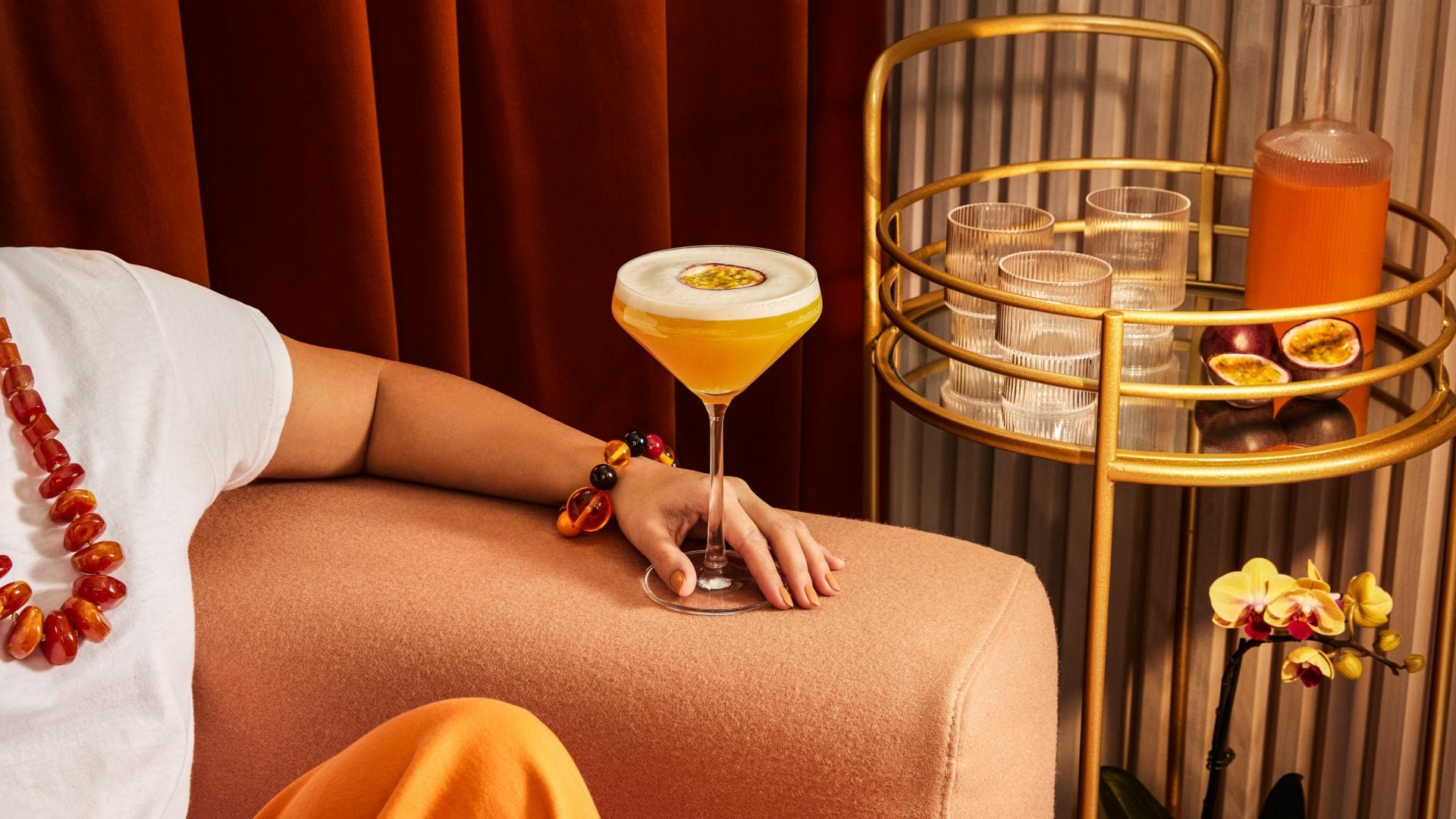 A woman enjoying a Passionfruit Martini Cocktail