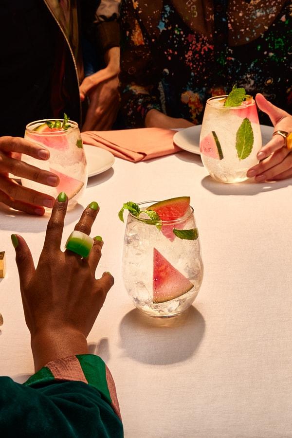 Guests at a dinner table drinking Smirnoff Zero Sugar Infusions Watermelon, Mint & Soda.