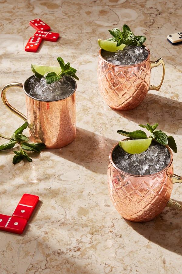 Mule cocktails on a table with dominoes