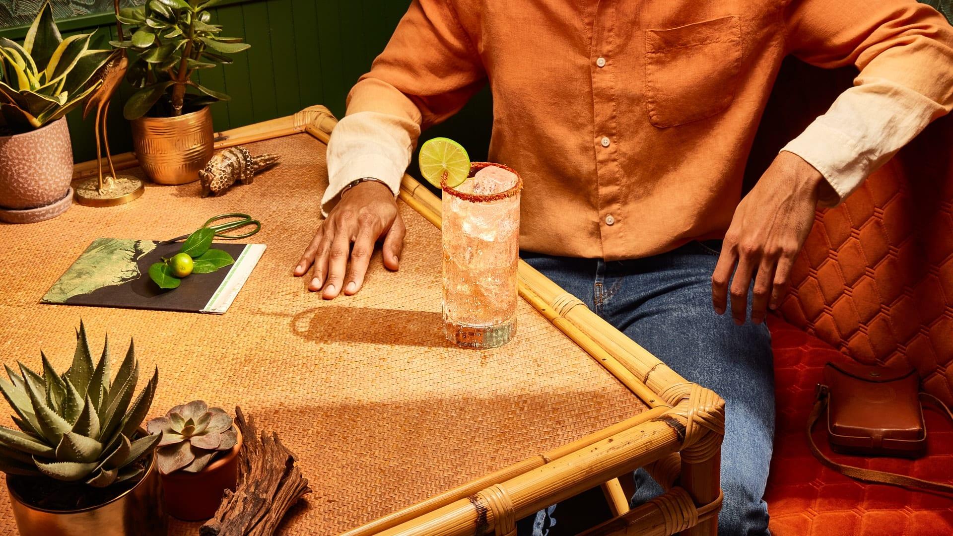 Man in a booth drinking Spicy Tamarind Paloma