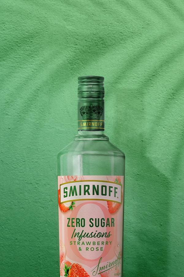 Smirnoff Zero Sugar Infusions Strawberry & Rose on green tropical background