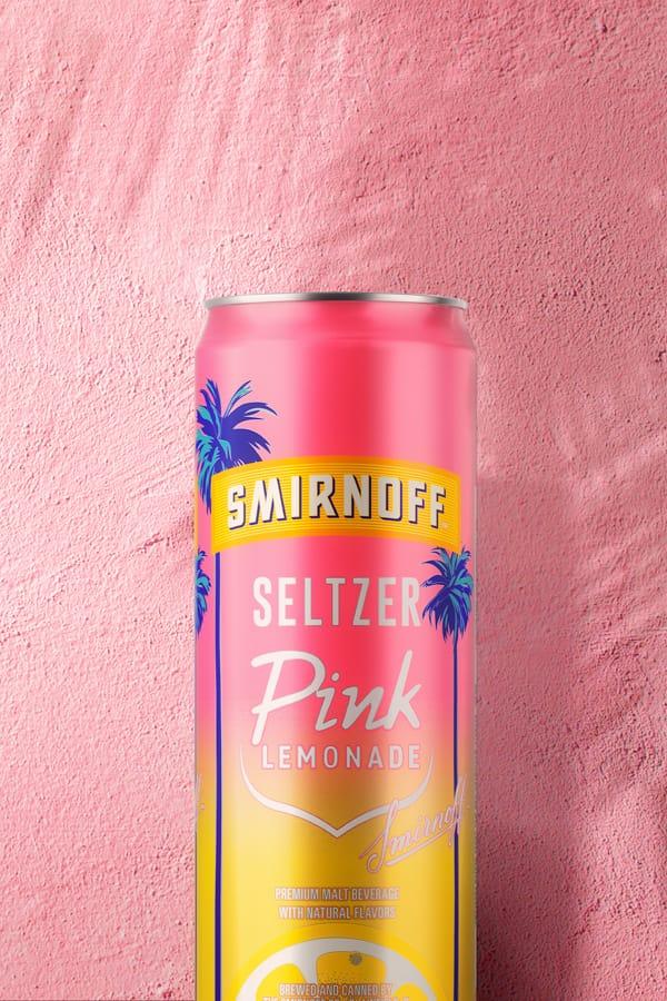 Smirnoff Pink Lemonade Seltzer on a pink background with palm trees