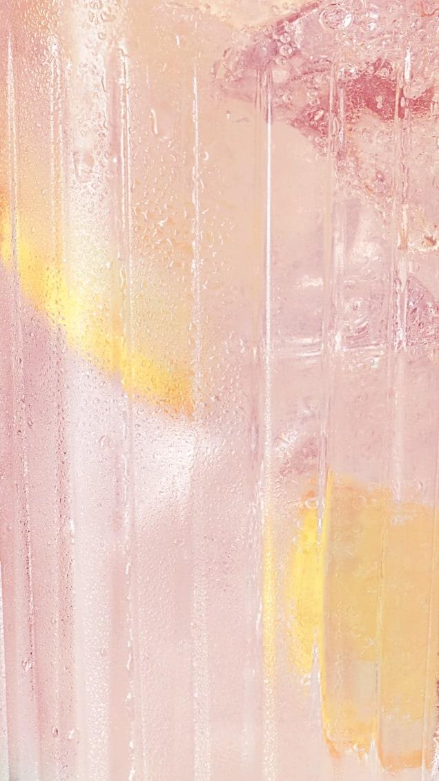 Pink Liquid with bubbles and lemons