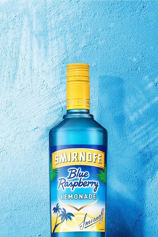 Smirnoff Blue Raspberry Lemonade on blue background with palm trees